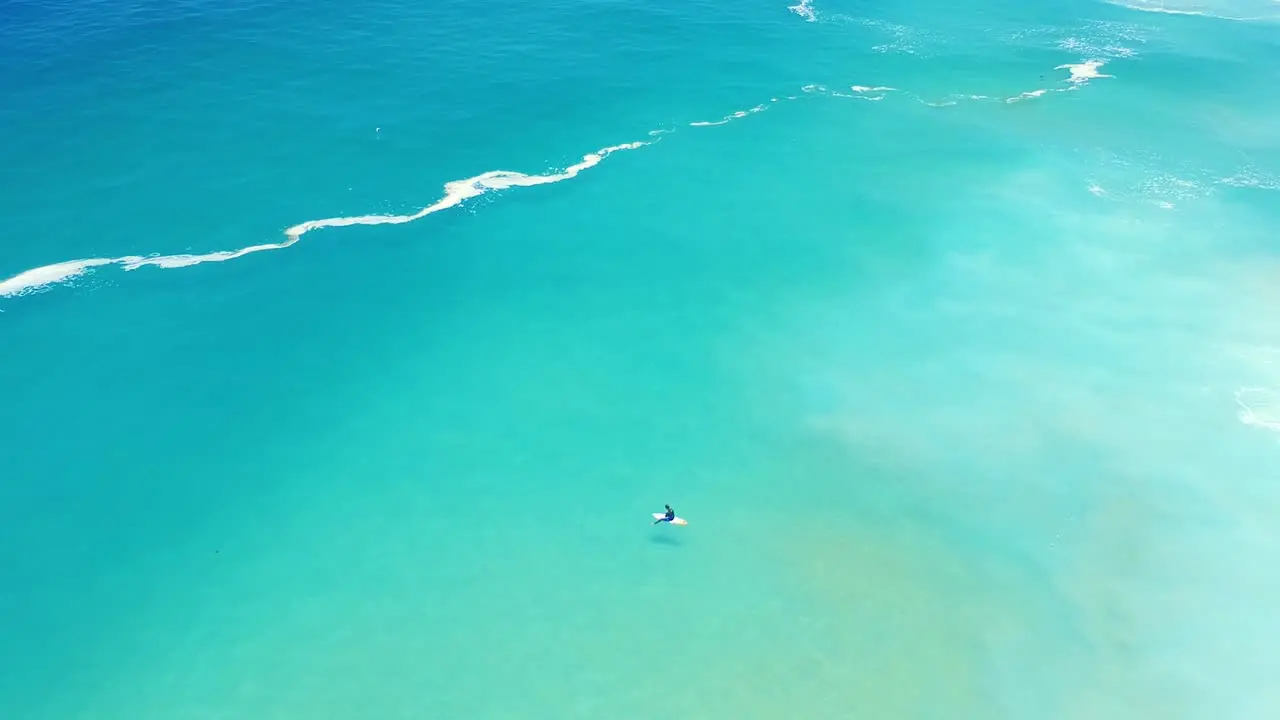 High Angle of surfer alone in ocean waiting on waves