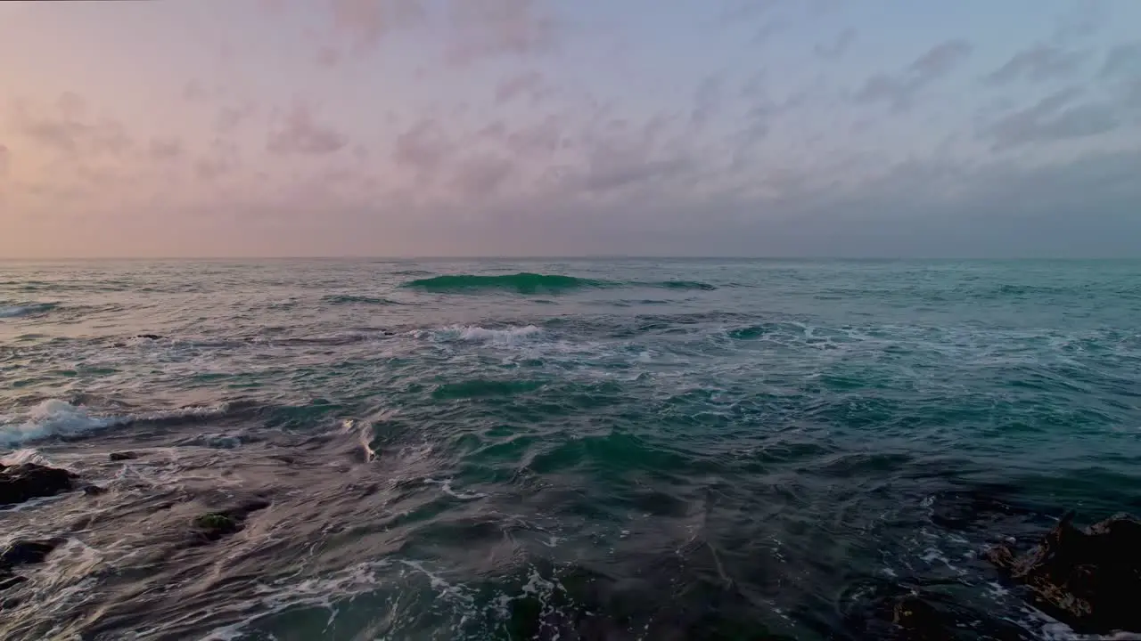 Drone moving backwards at a rocky coast