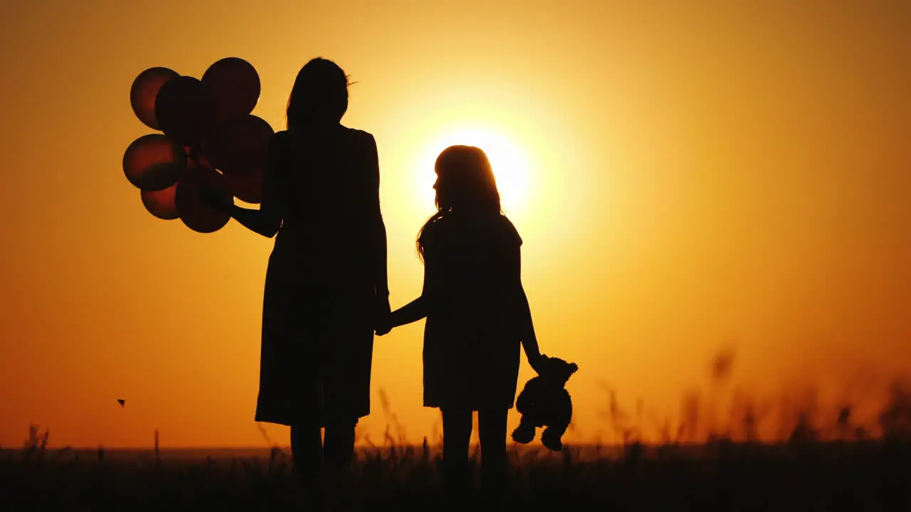 Mom With Dock Stand At Sunset Keep Balls And Toy Bear