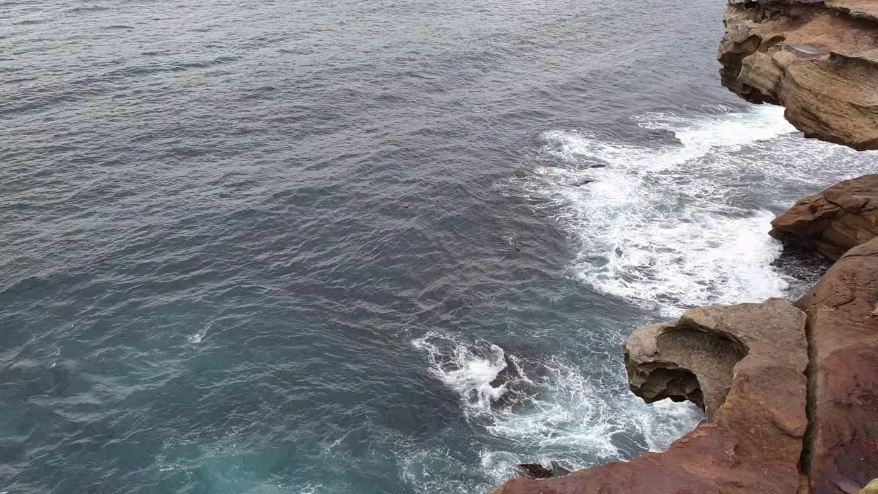 Blue Waves Crashing On Rocky Cliff In Bronte Beach Australia Closed During The Coronavirus