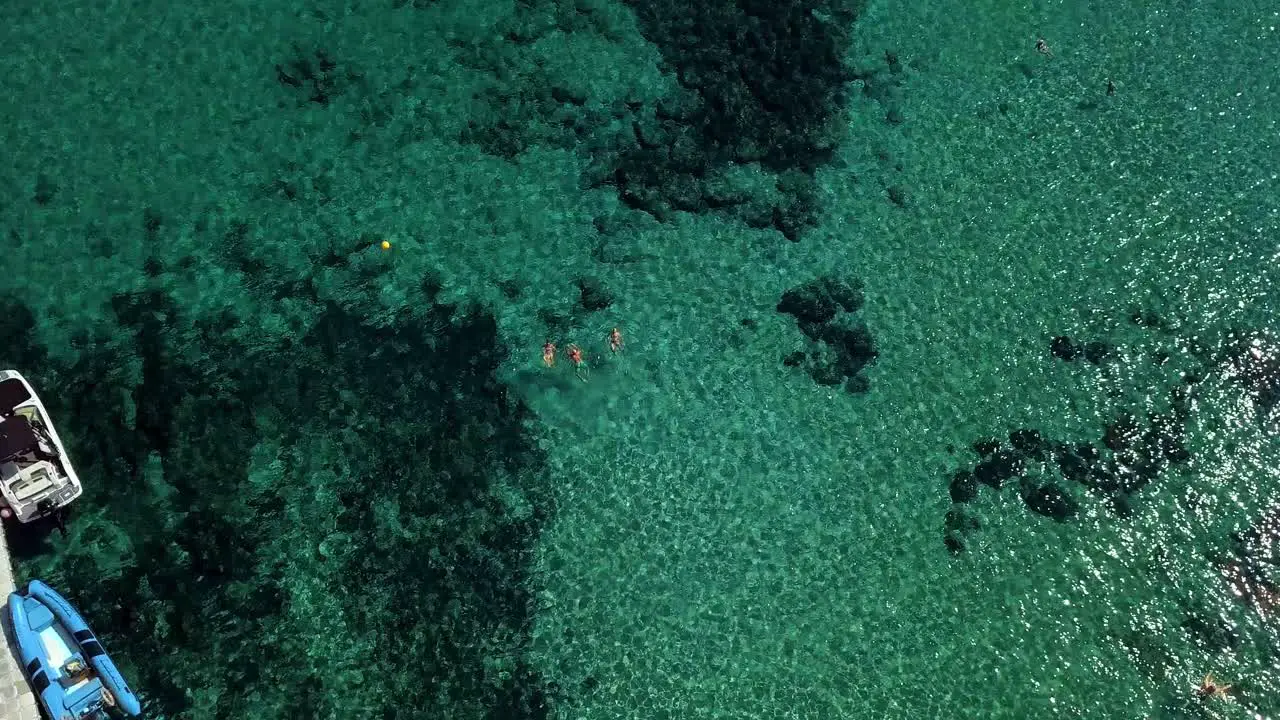 drone shooting with clear turquoise water of the Mediterranean Sea people bathe