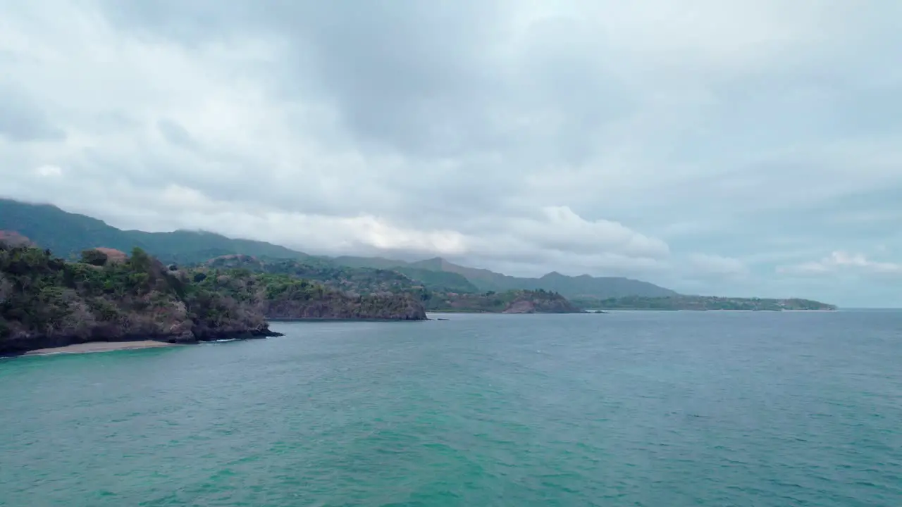 Cloudy day fly by of stone and sand beach fronts