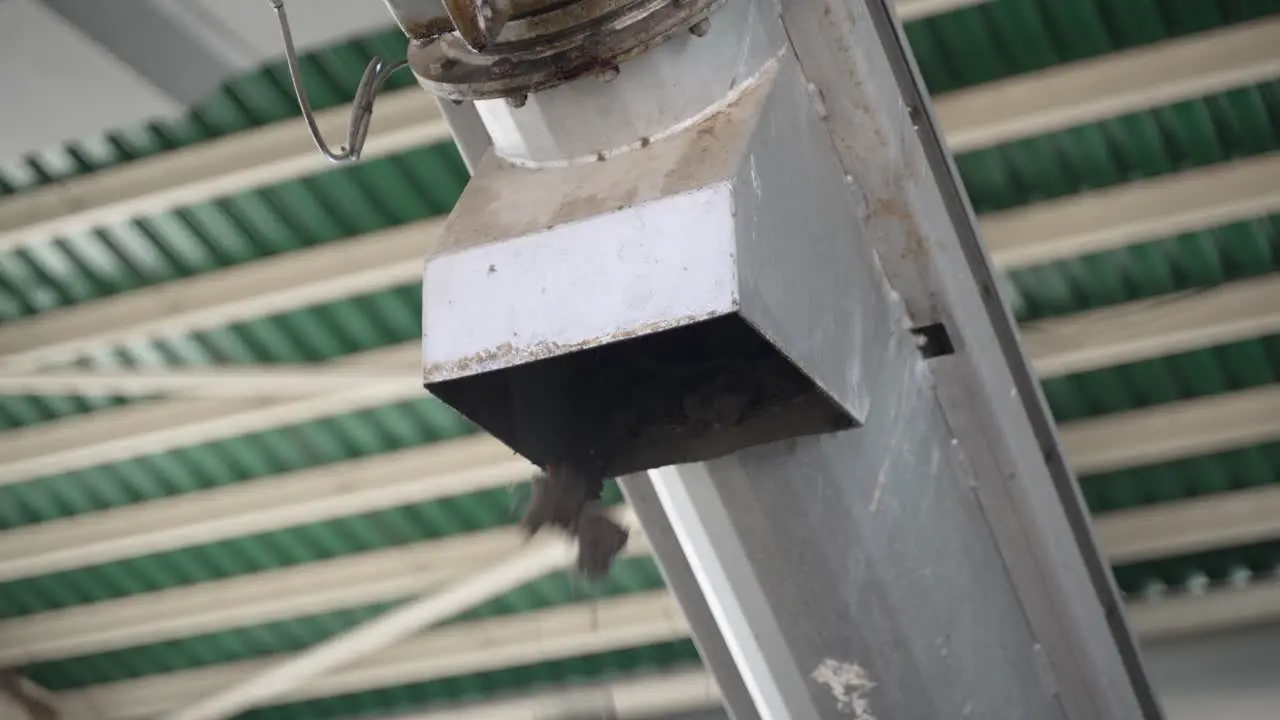 Grit from wastewater falling down the conveyor