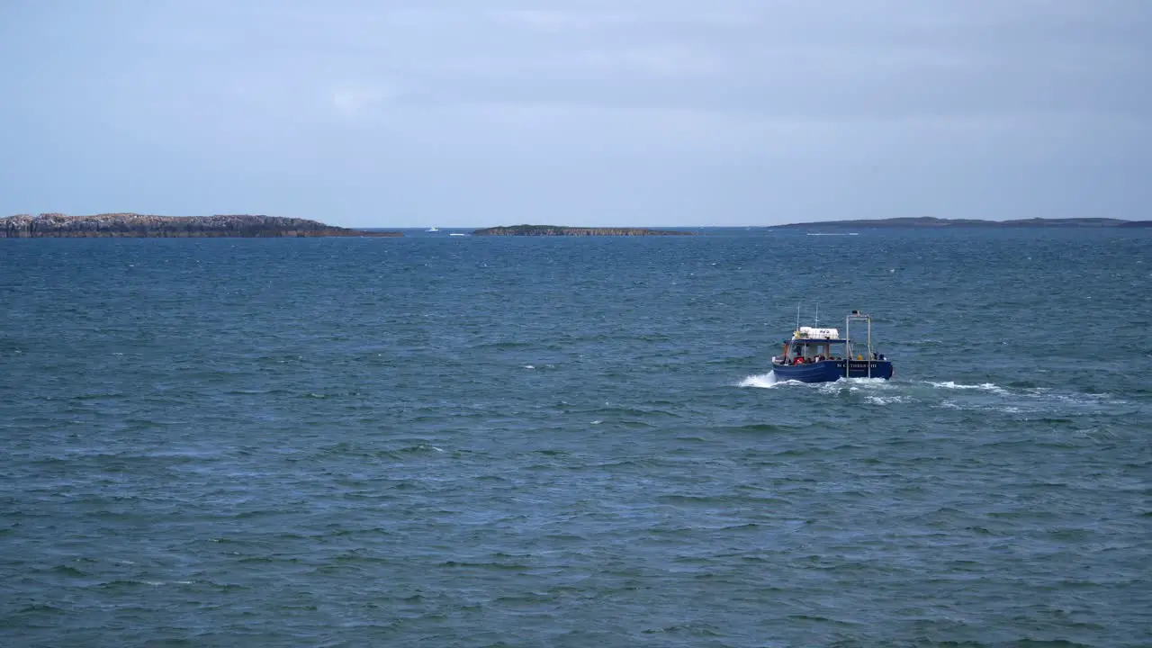 A small passenger ferry transports tourists and locals from Seahouses Harbour to the Farne Islands in the North Sea off the coast of Northumberland