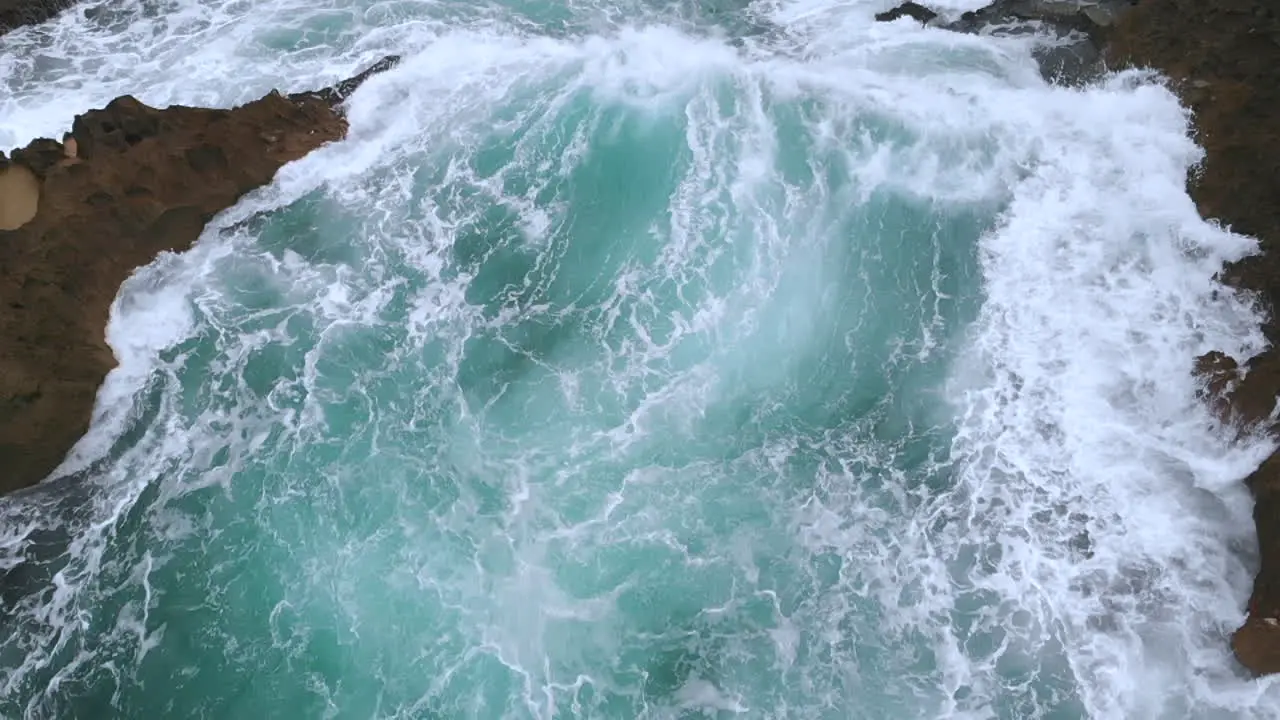 Slow motion waves crashing on rocks in the ocean