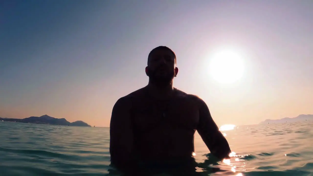 man silhouette at sunrise on the beach