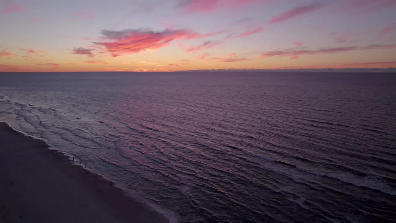 Aerial Drone Orange Sunset Skies Over Beach Of