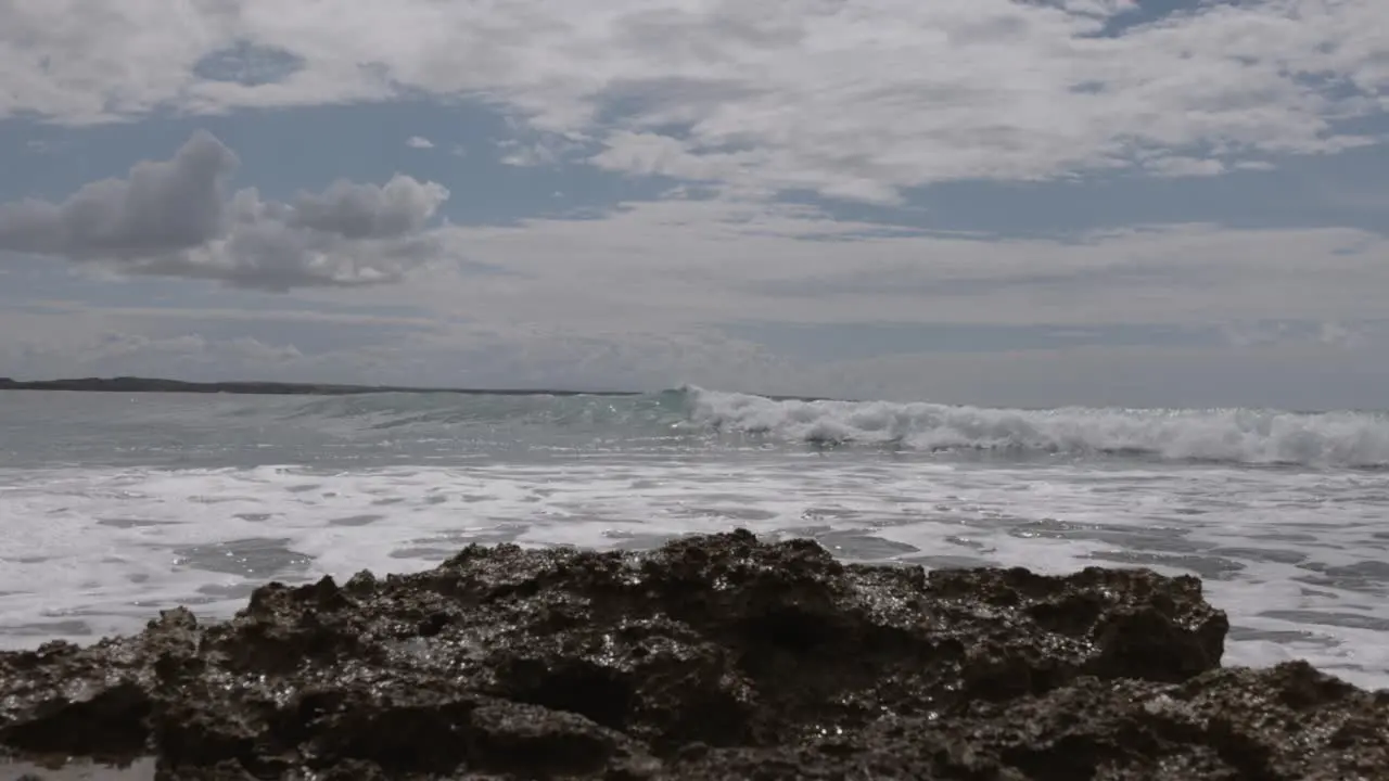 Rocky Shore With Crashing Sea Waves In Cloudscape Sky In Mediterranean Sardinia Island Italy