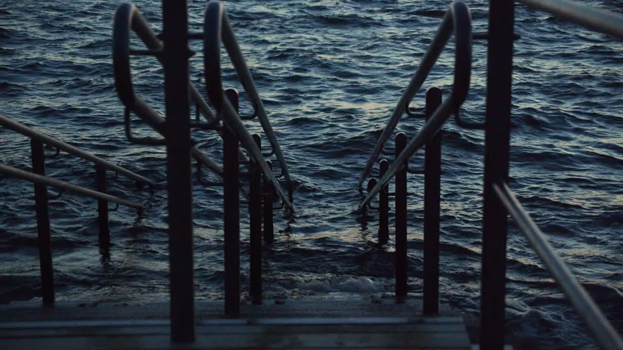 Stairs with handrails for descending to swim in rough sea from the rocky shore