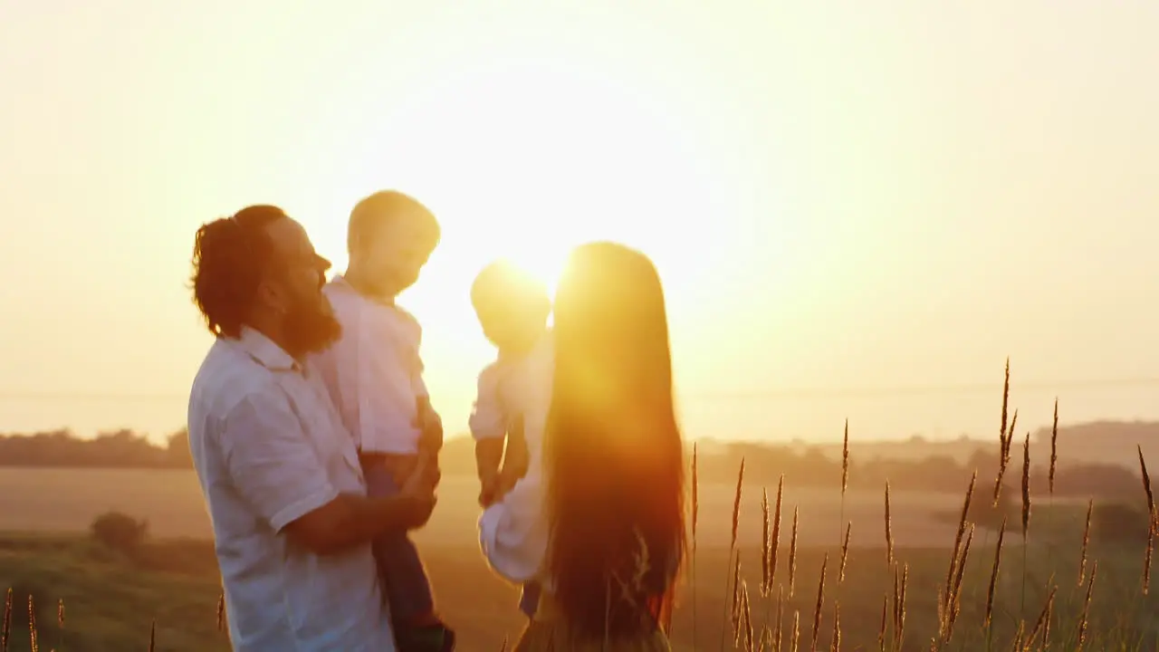 The Bearded Daddy Together With His Mother And Their Young Sons Communicate With Each Other Against 