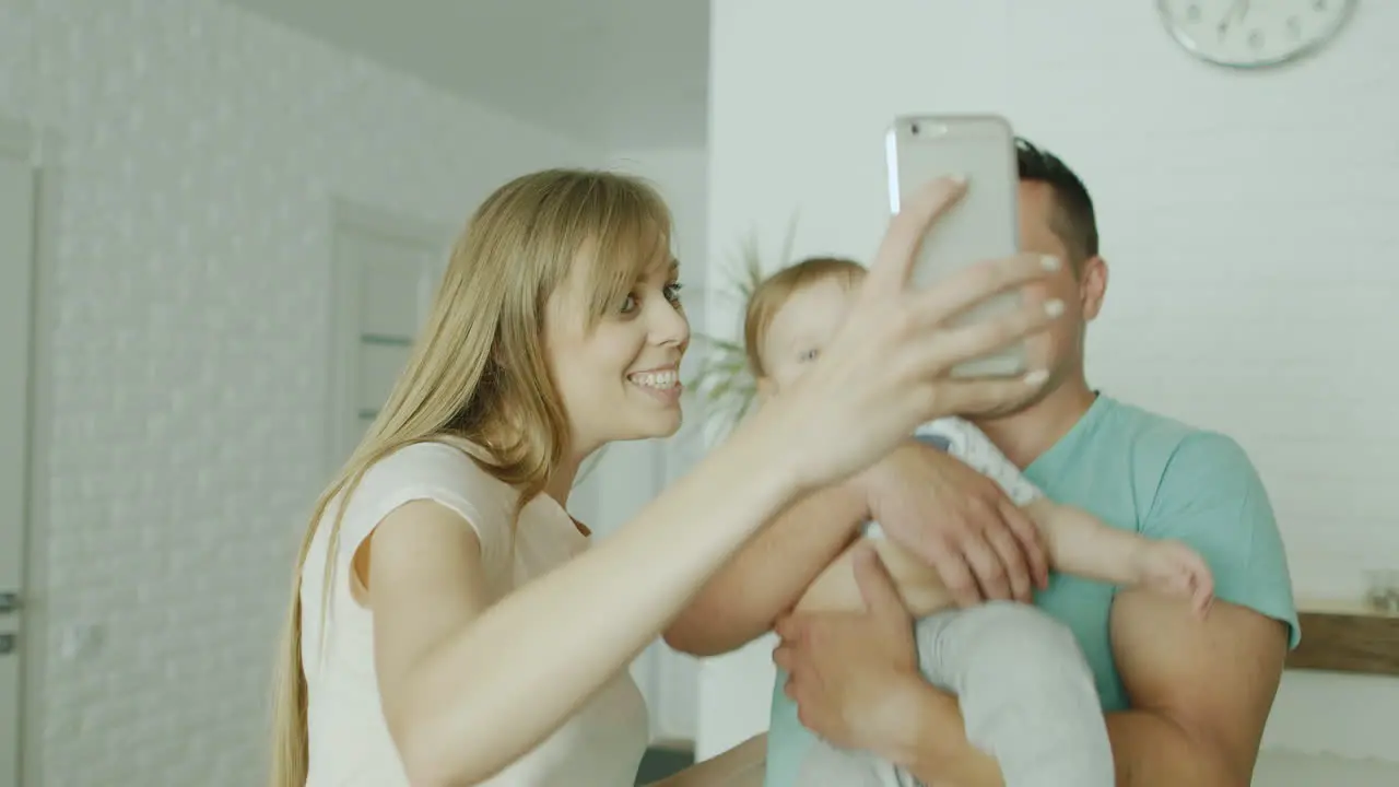 A Young Couple Makes A Selfie Along With Her Baby Boy 1