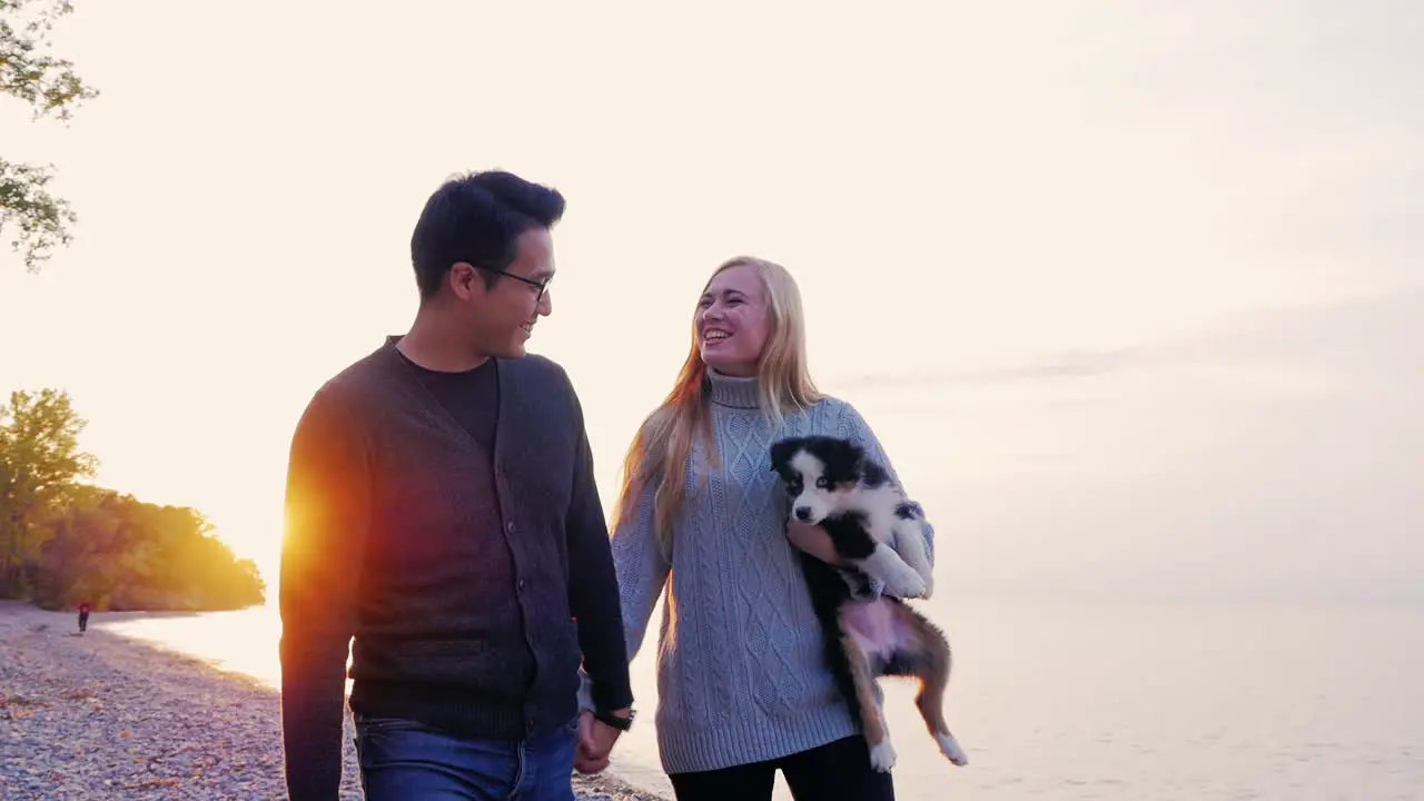 Young couple walking the dog