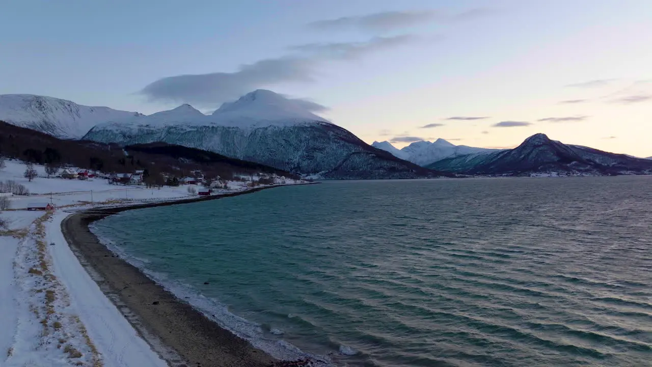 Landscape shot of snow-capped mountains and the sea on the coast of Norway