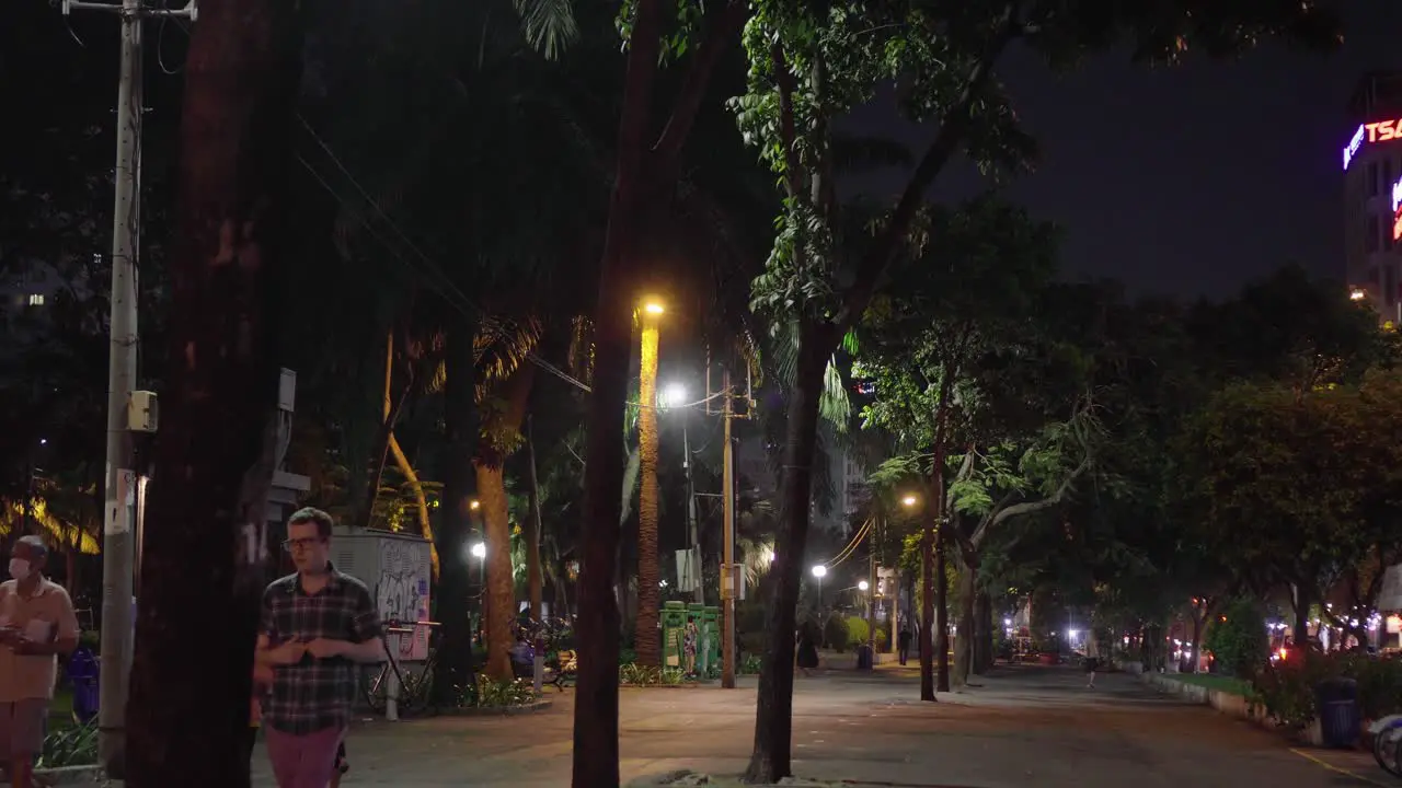 Park-goers strolling at night in a park in Ho Chi Minh City Vietnam