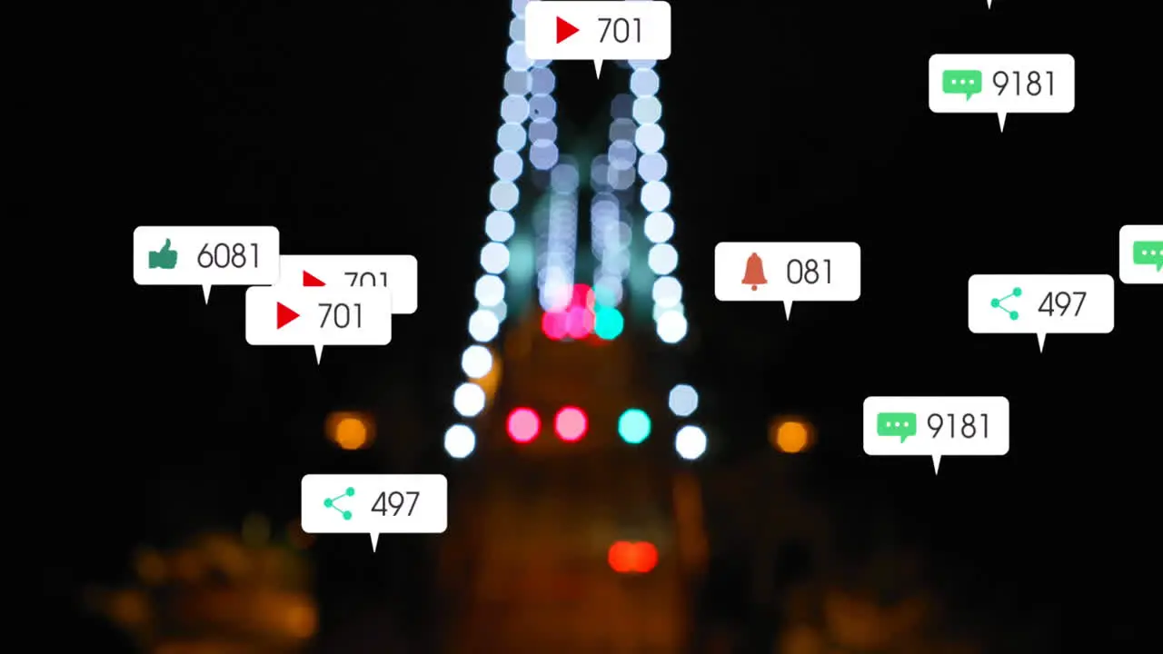 Animation of social media icons falling against blurred aerial view of night city traffic