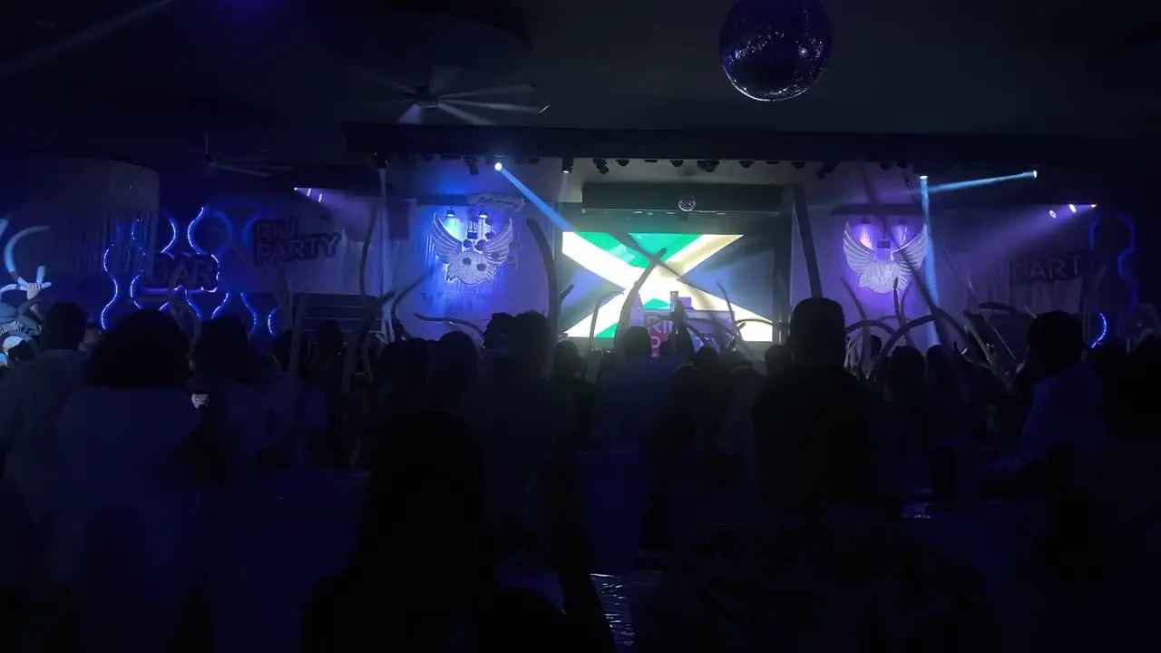 People are having fun with balloons and dancing during a nightclub party night