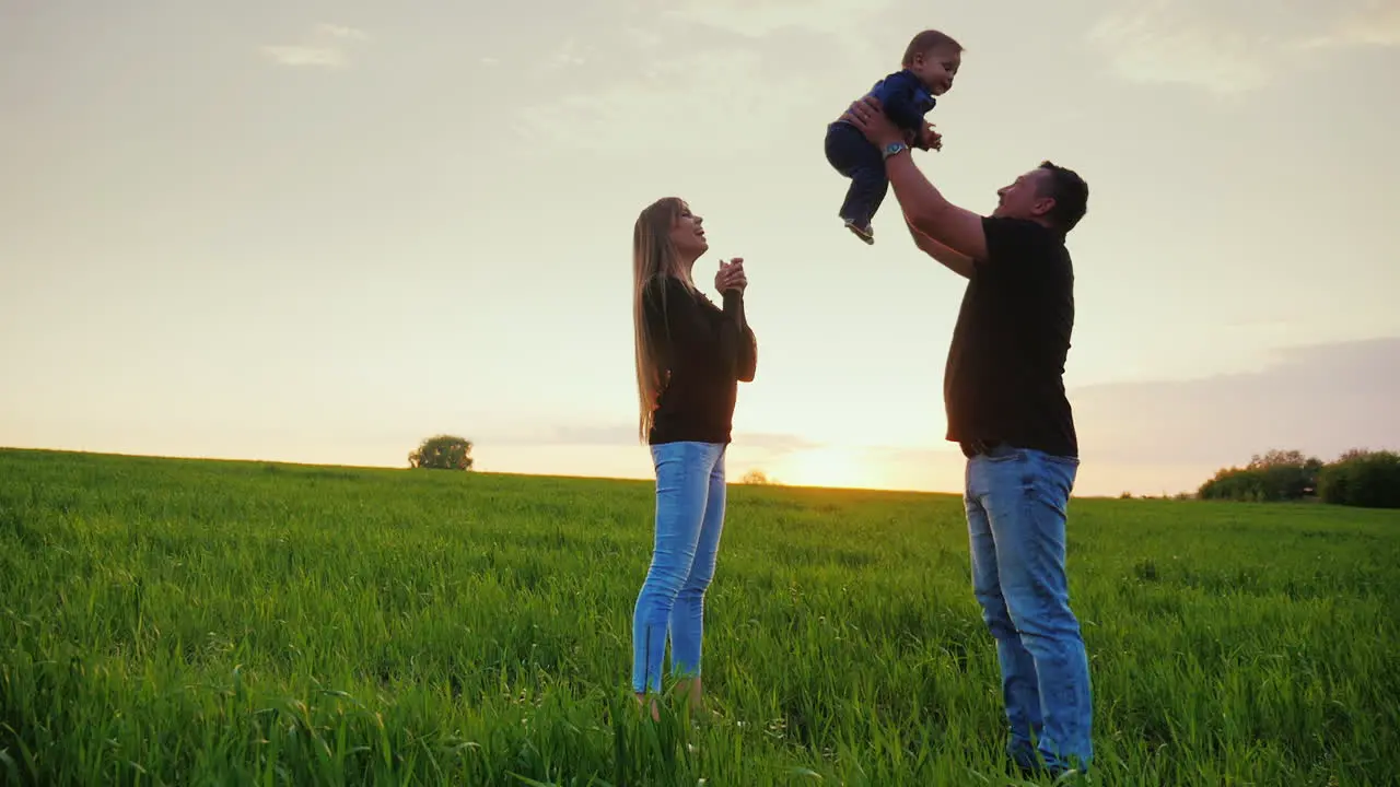 A Young Couple Is Having Fun With Their Young Child In A Picturesque Place 1