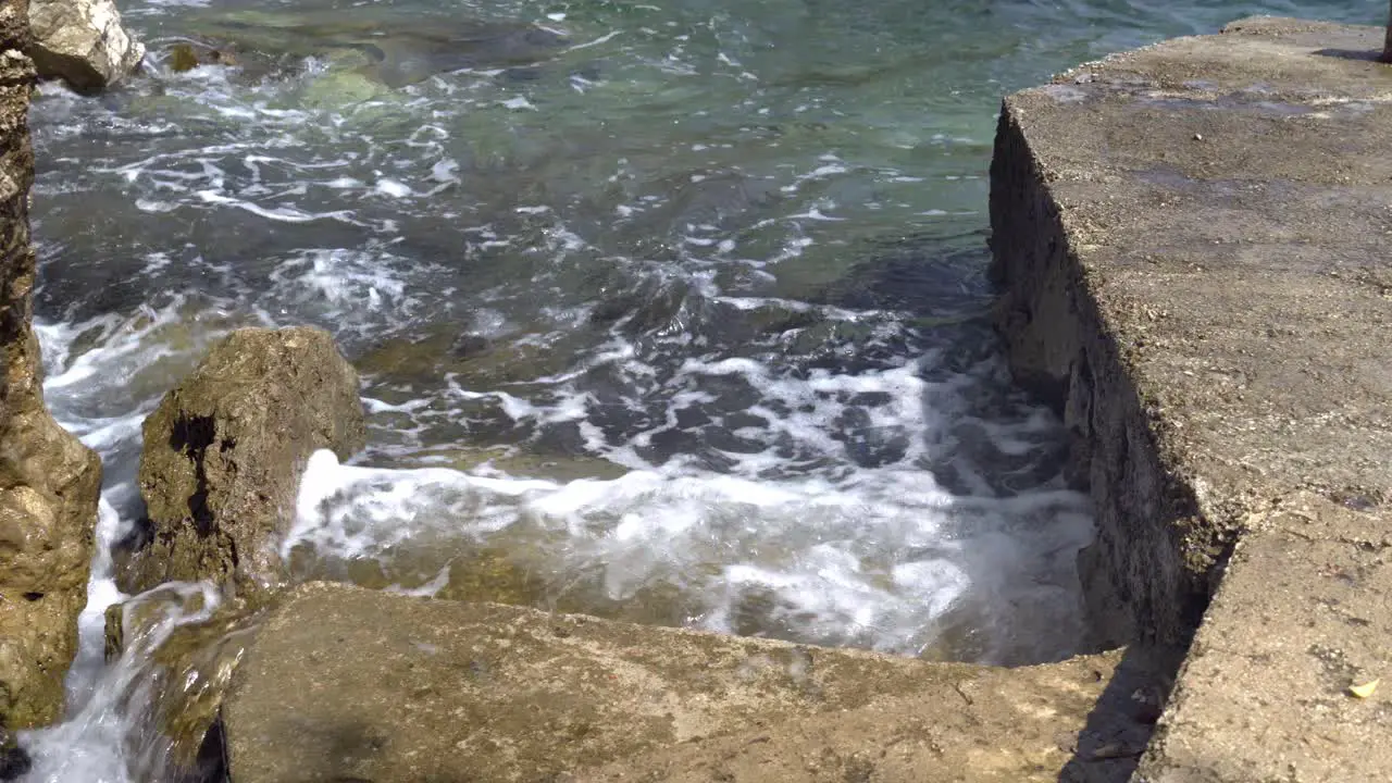 Waves hitting concrete stairs in an alcove on Mljet Island Croatia in the Adriatic Sea