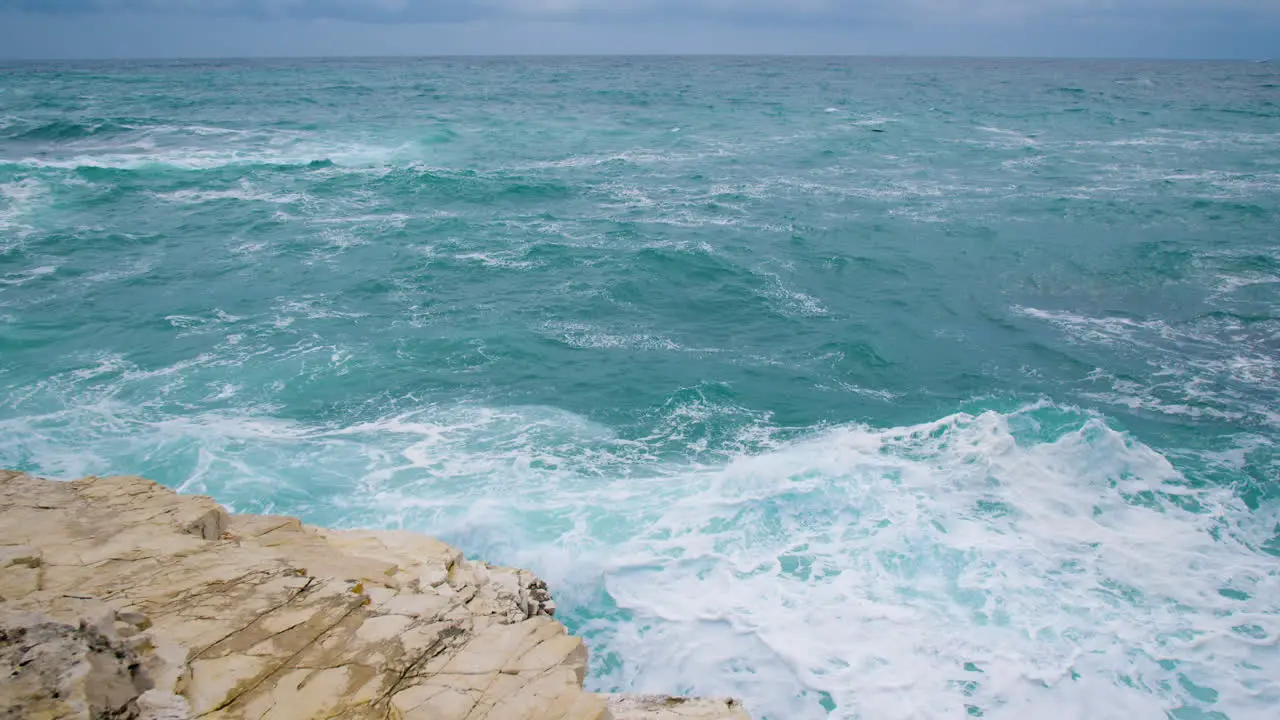 Waves breaking on rt Kamenjak rocky shore restless sea