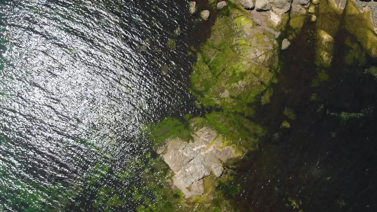 Vertical aerial shot of rocky sea cost in sunny summer day-1