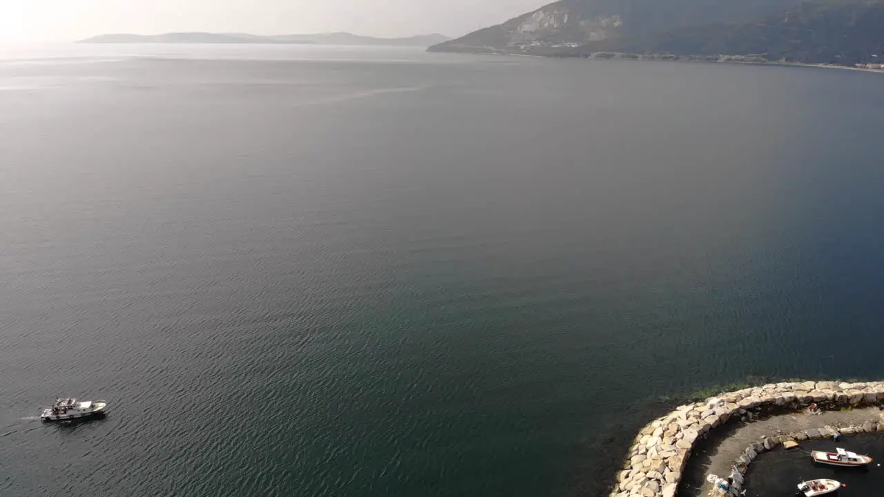 Aerial downward flight while the white boat is passing on the sea Turkey