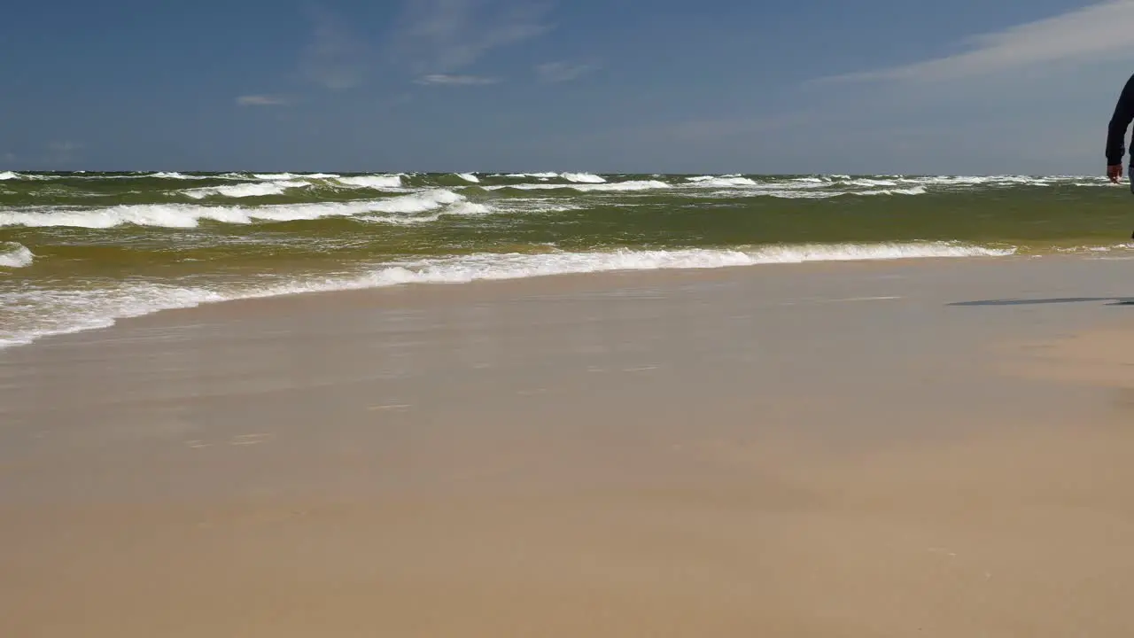 Obese Couple Walking in Front of Camera on Sandy Beach