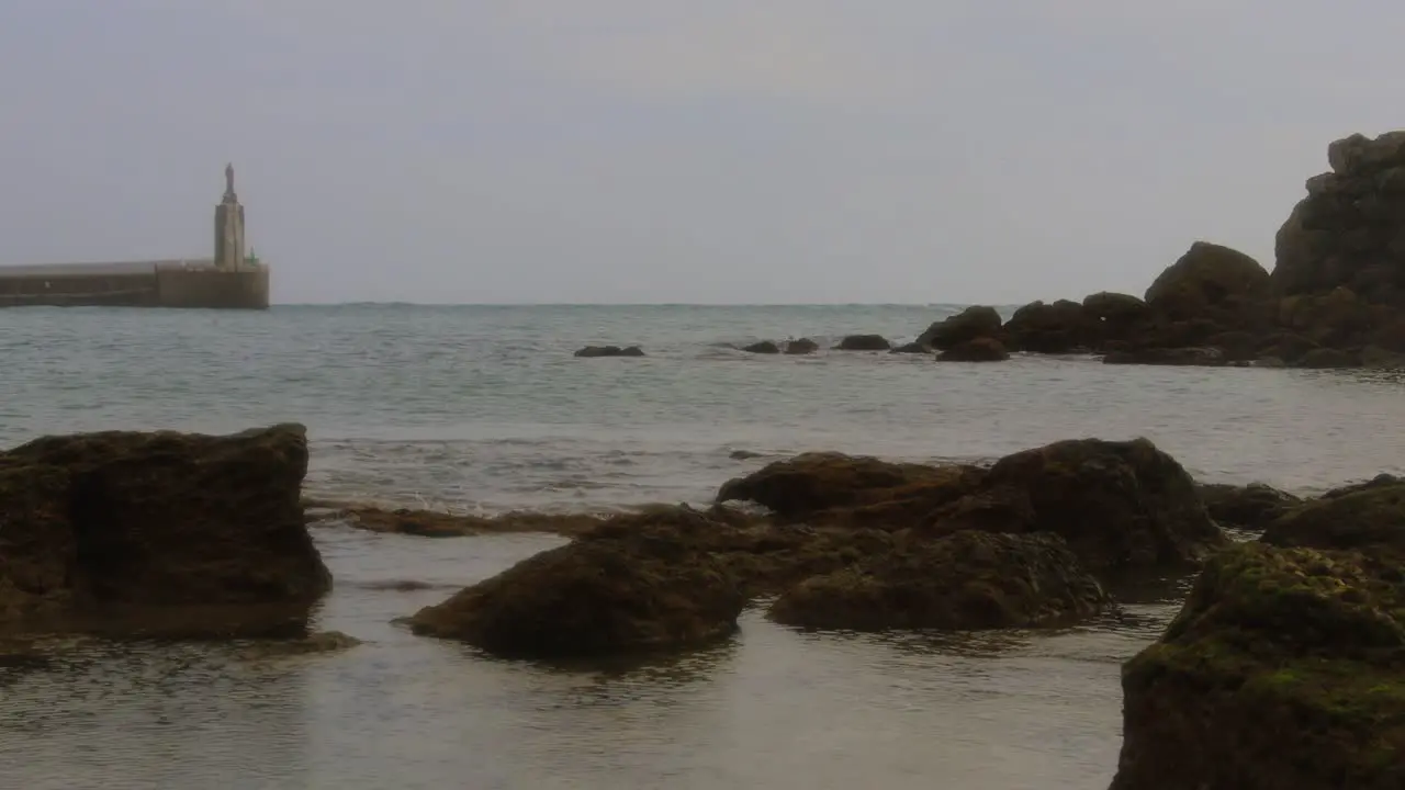 Tale Like Scene at the Sea with Rocks and Statue in the Distance