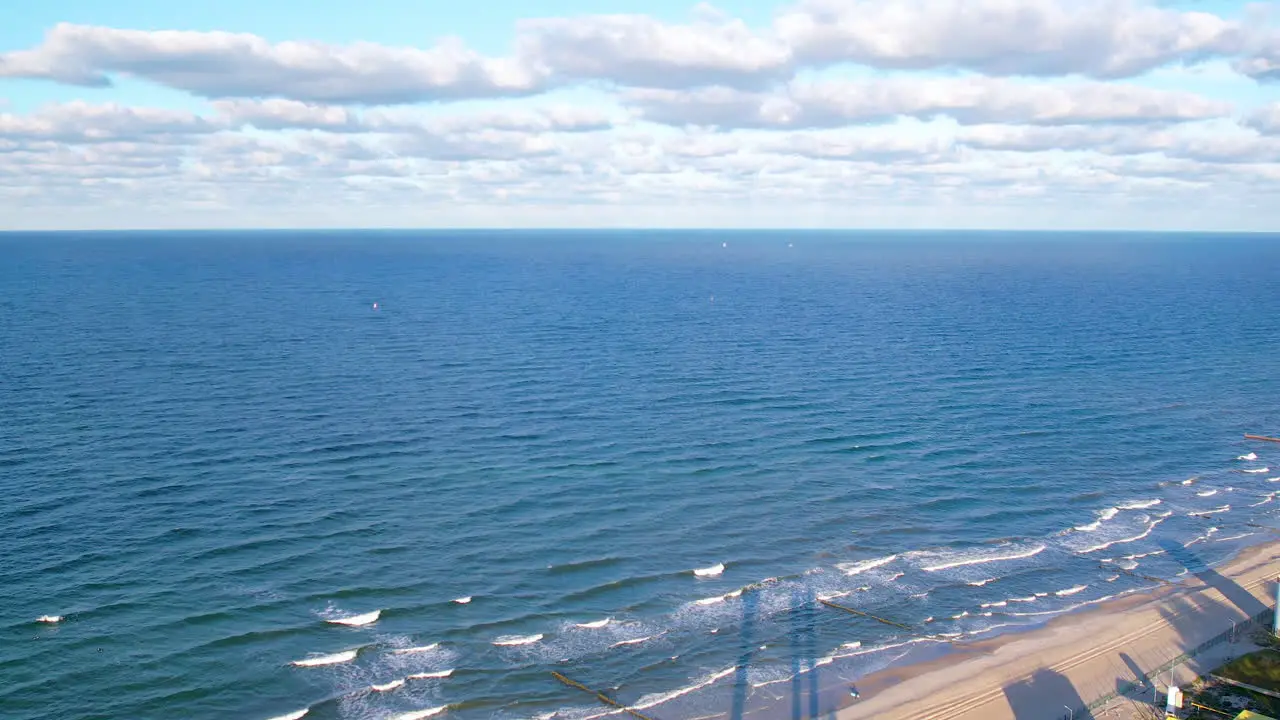 View Of Vast Expanse Of The Baltic Sea With Aerial Dolly Back Over Beach Coastline At Wladyslawowo