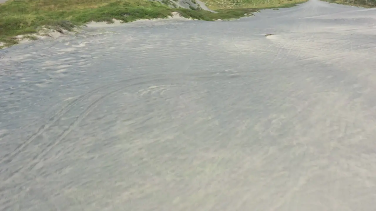 Flying over some dunes next to the sea