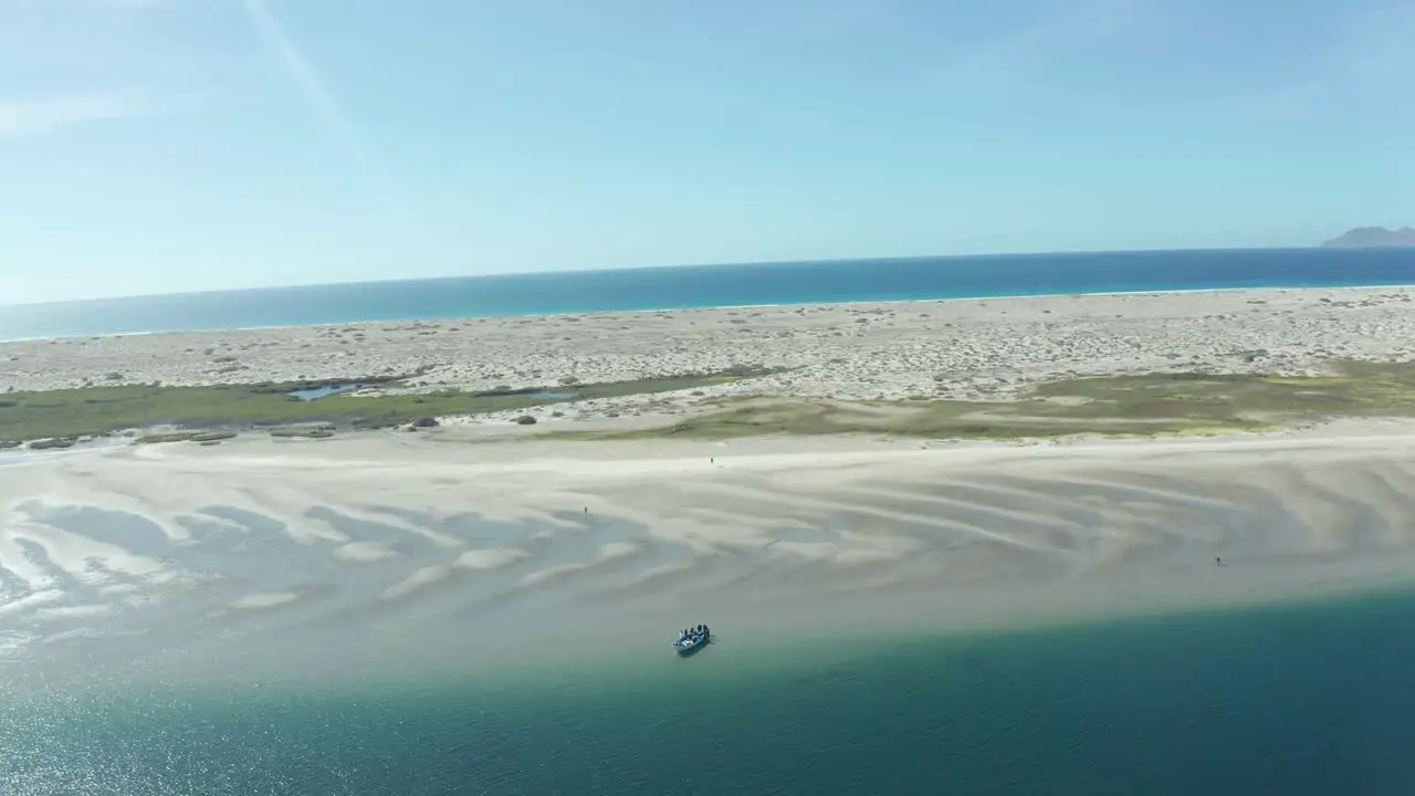 drone fly by a beach whit a boat in the shore