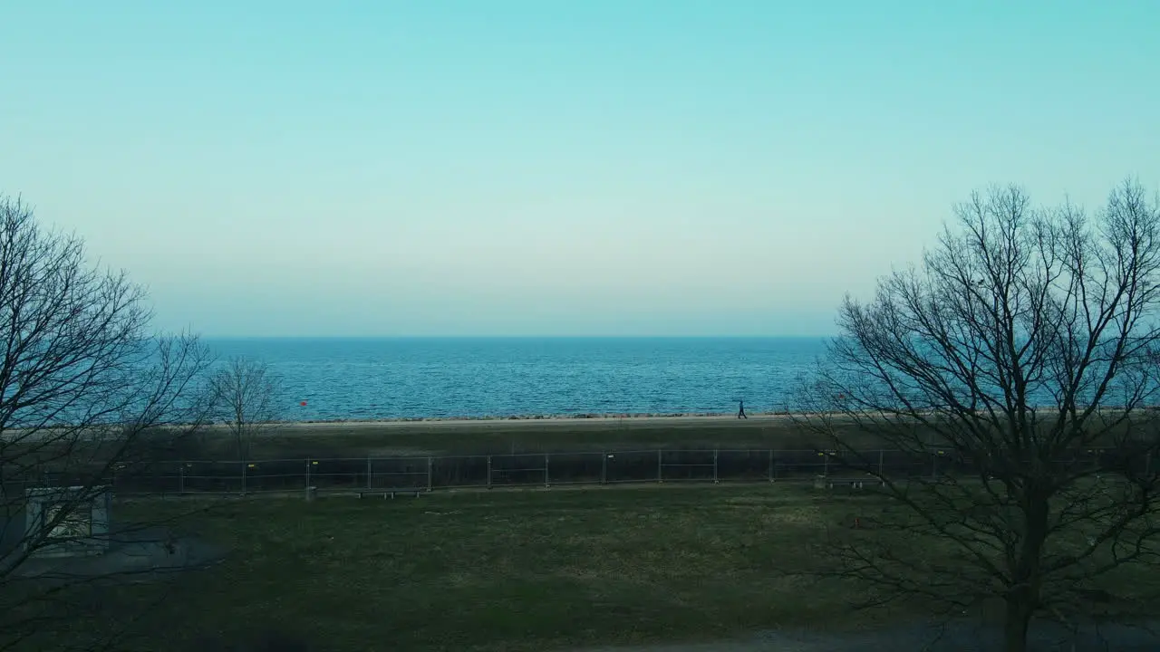 Aerial drone take off revealing Baltic sea cot shore in Westerplatte Poland early spring