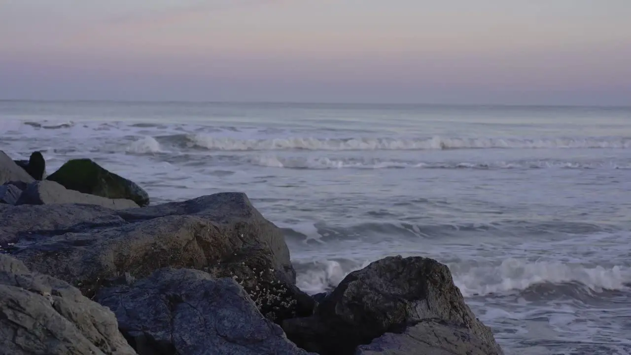 Blue hour with pink sky at the beach with rocks in Ocean City New Jersey