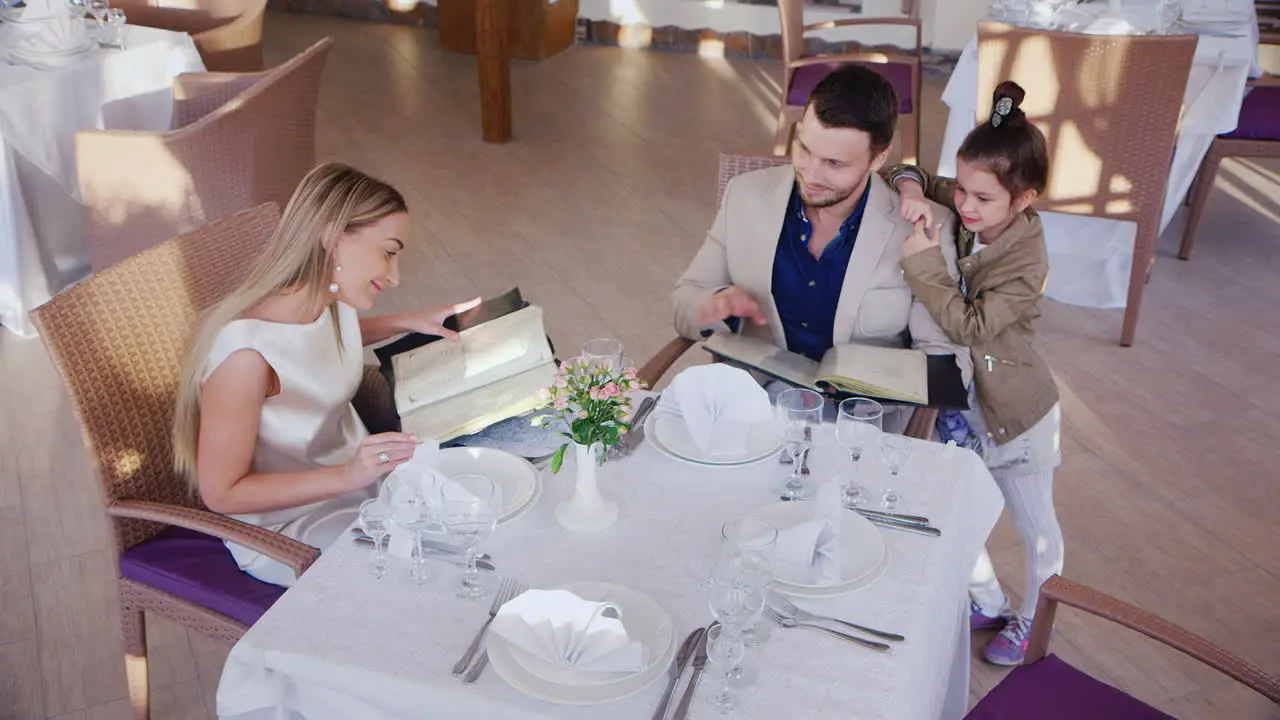 Family Read Menus in Restaurant