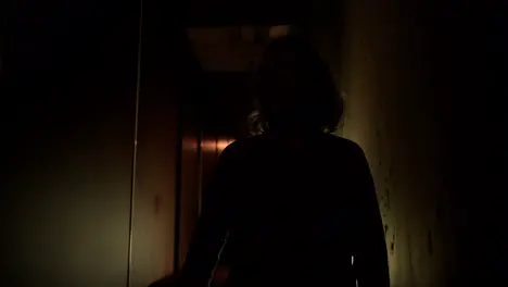 Woman in the hallway at night