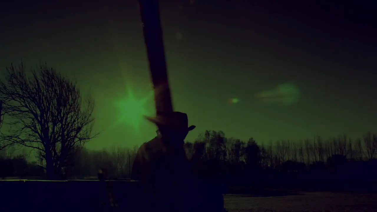 Cowboy's Silhouette in the Winter Landscape during Polar Green Night