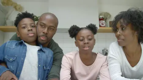 Joyful Family Talking Directly into Webcam During Video Call