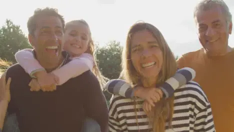 Low Angle Shot of Children Piggy Backing On Their Parents 01