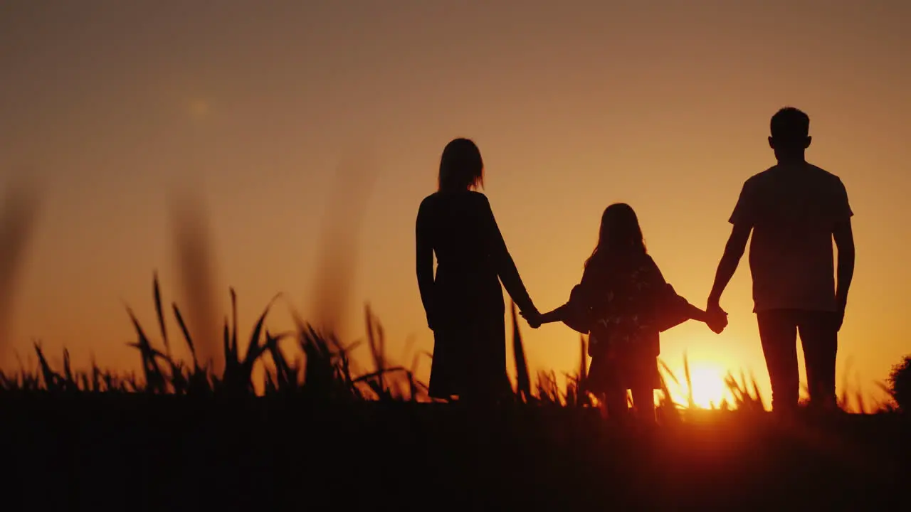 Parents With The Child Stand In A Picturesque Place Admiring The Sunrise Holding Hands Happy Family 