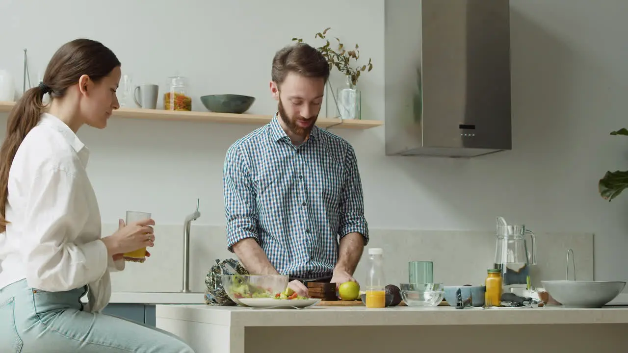 Glückliches Paar Das In Einer Modernen Küche Plaudert Und Das Mittagessen Gemeinsam Zubereitet