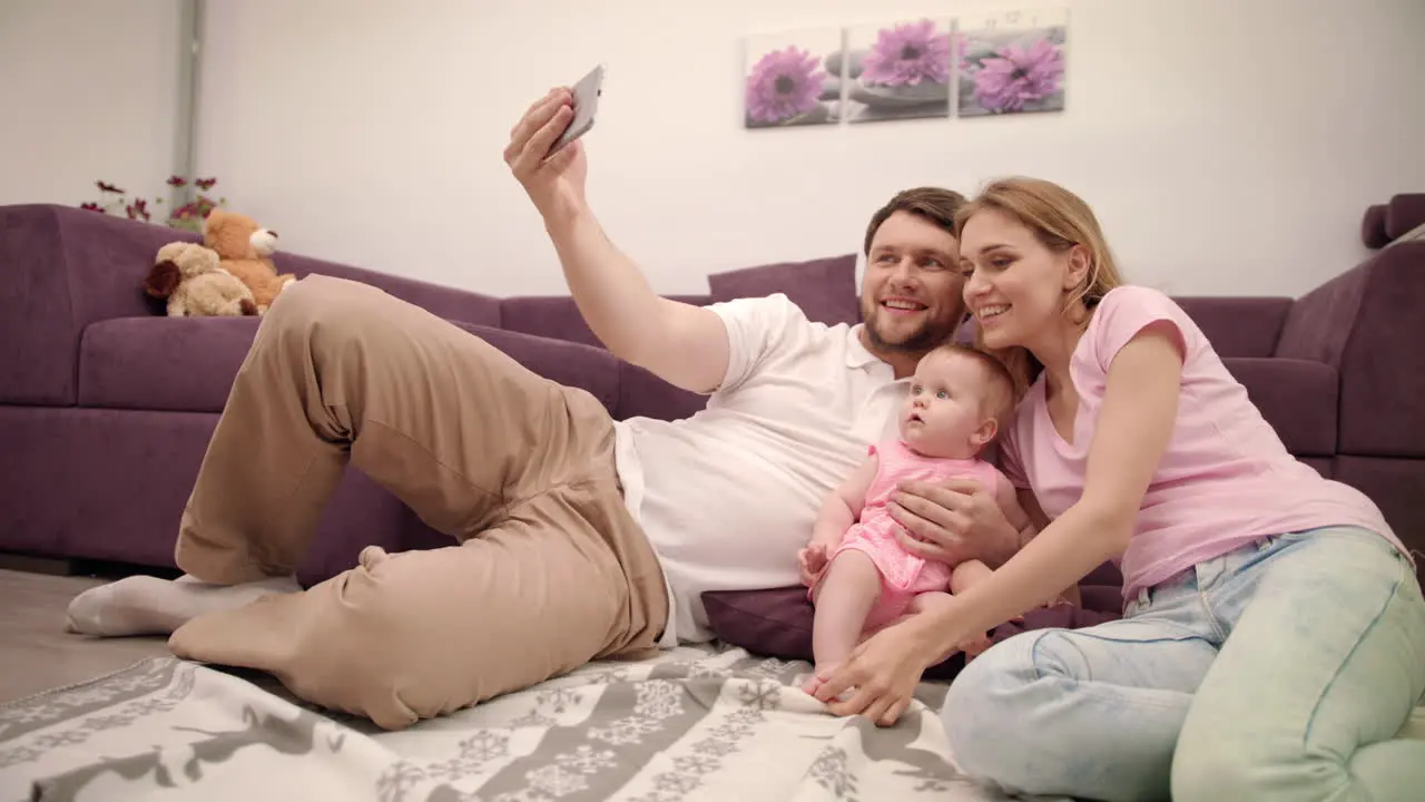 Happy family making selfie at home Father take photo with wife and daughter