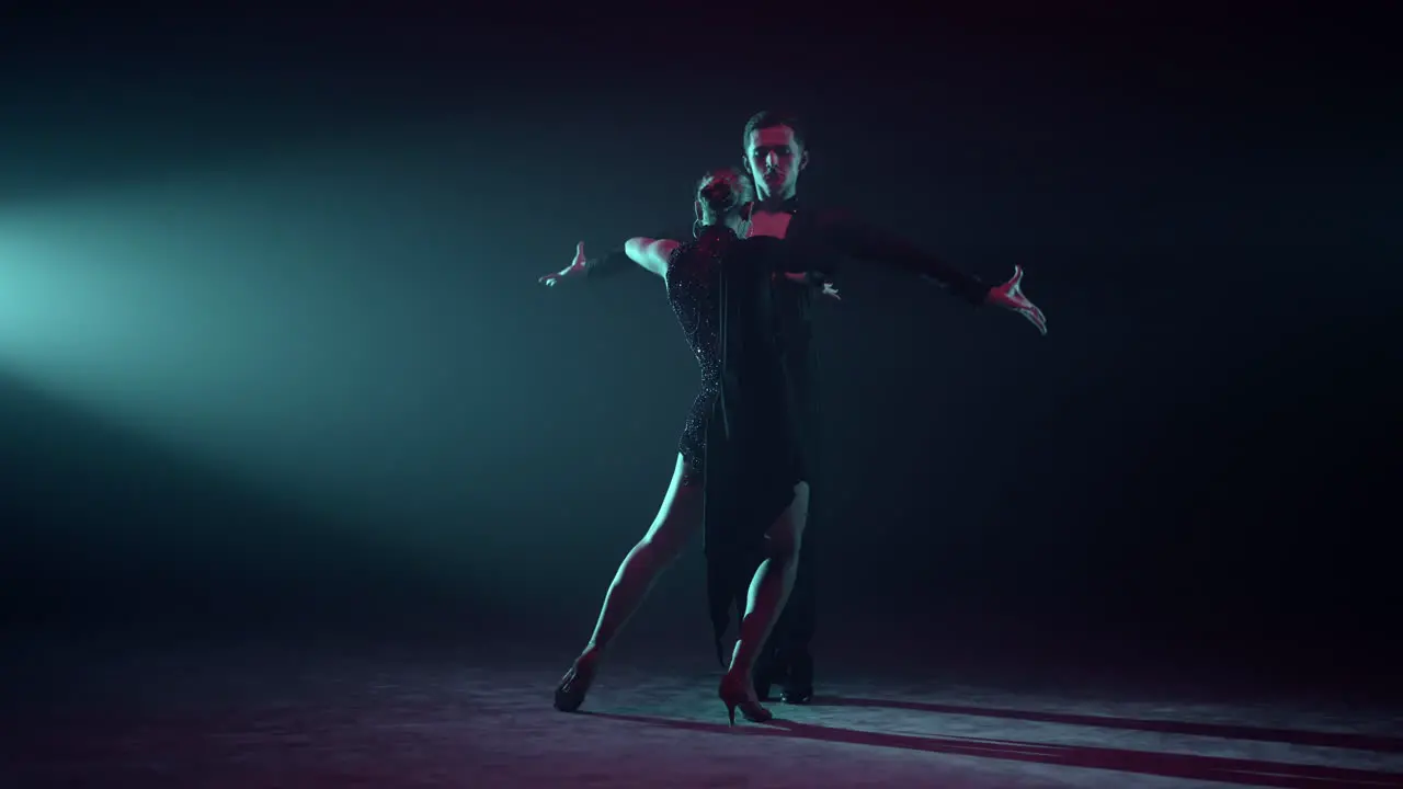 Couple performing latin dance on stage Ballroom partners dancing indoors