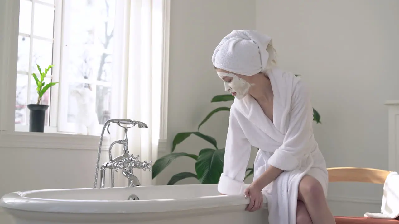 Woman With Face Mask Preparing For A Relaxing Bath