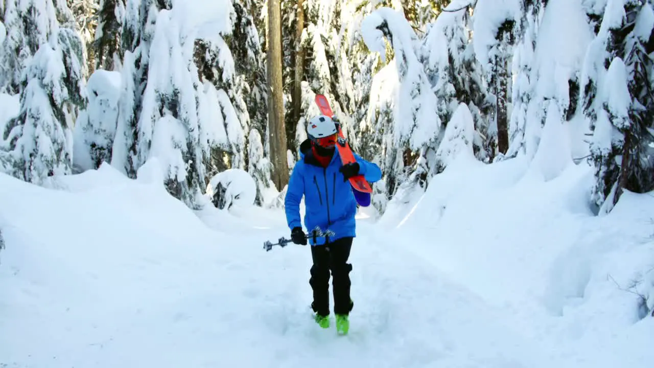 Person walking with snowboard and ski pole 4k