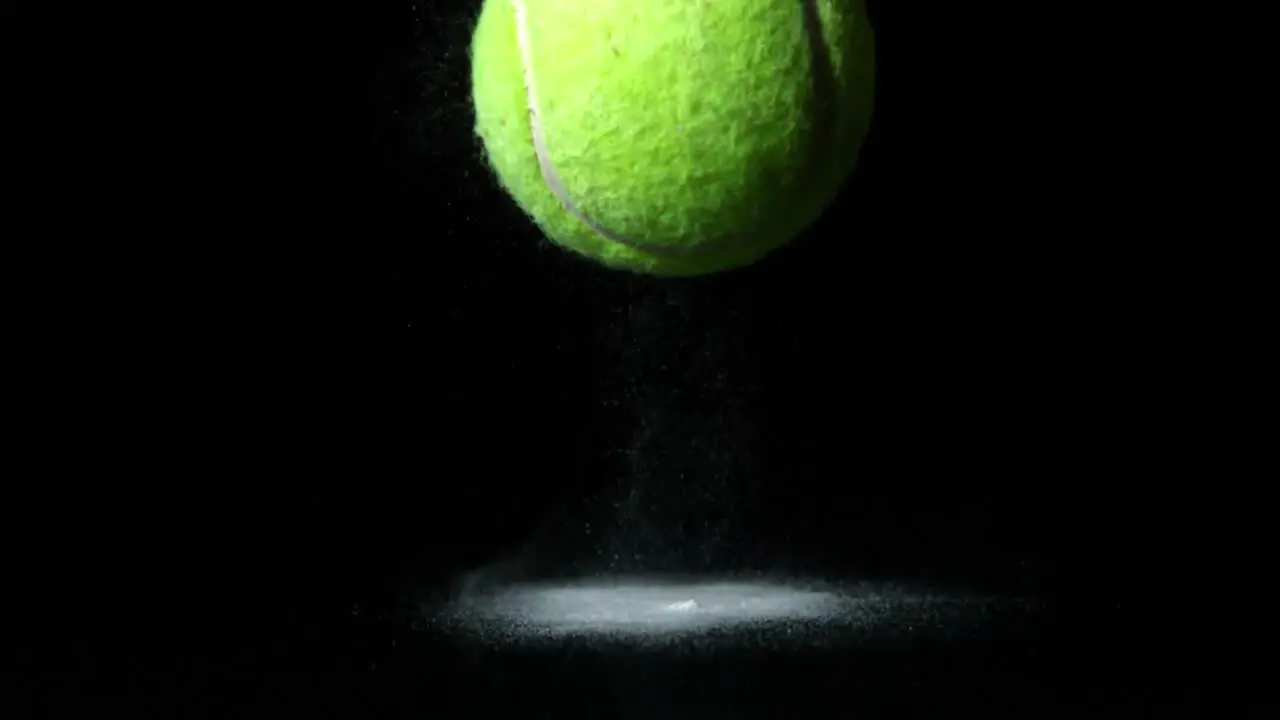 Tennis ball falling on black background