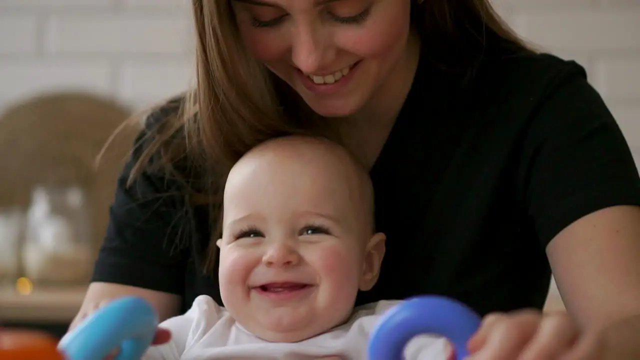 Young Caucasian Mother using Tablet with her Baby Daughter Slow Motion 120 fps Mother showing her Child digital Tablet Children and Technology concept Toddler girl Cinematic family