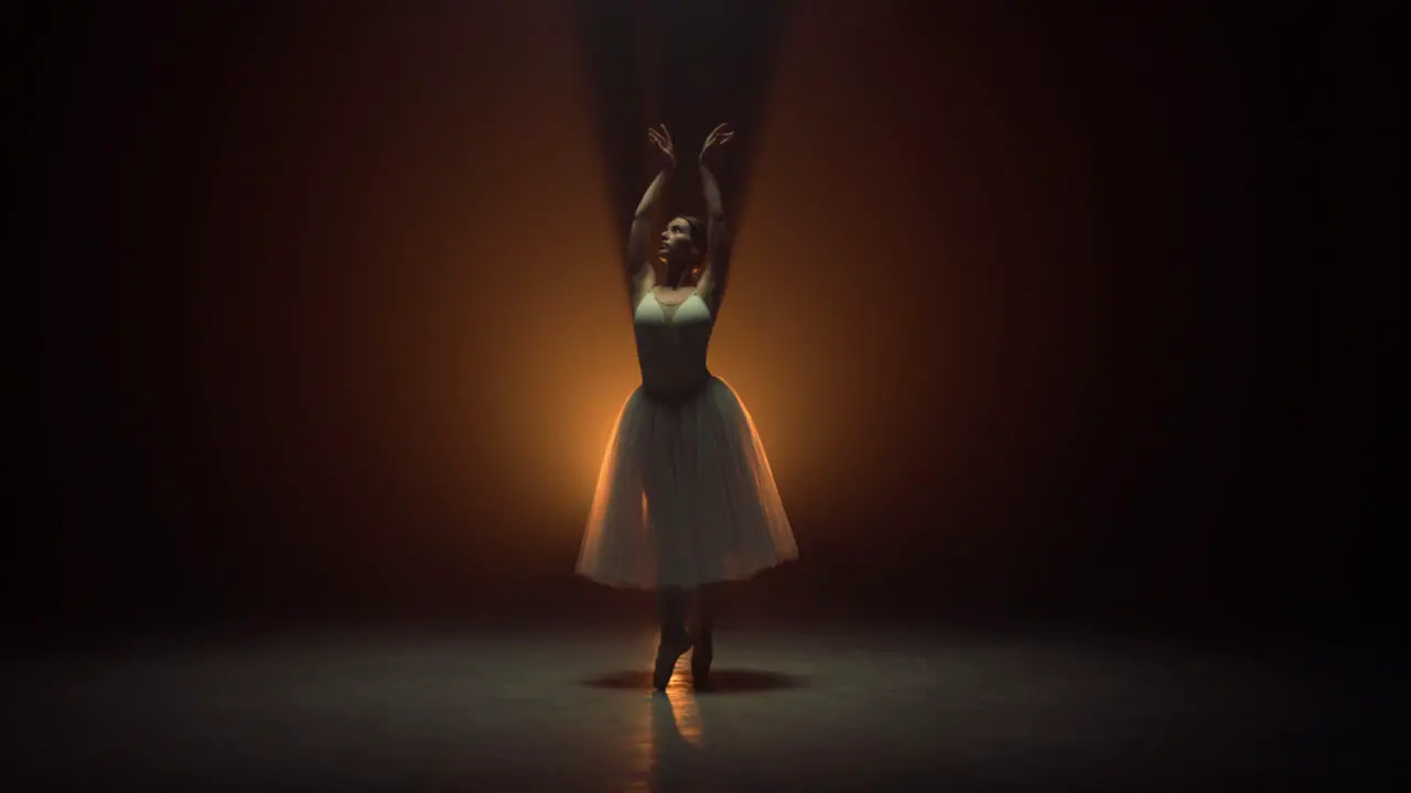 Flexible ballerina dancing on tiptoe on stage Ballet dancer wearing tutu skirt