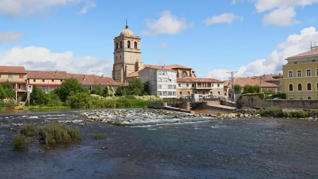 Church in the center of town seen from the mighty river on a summer day