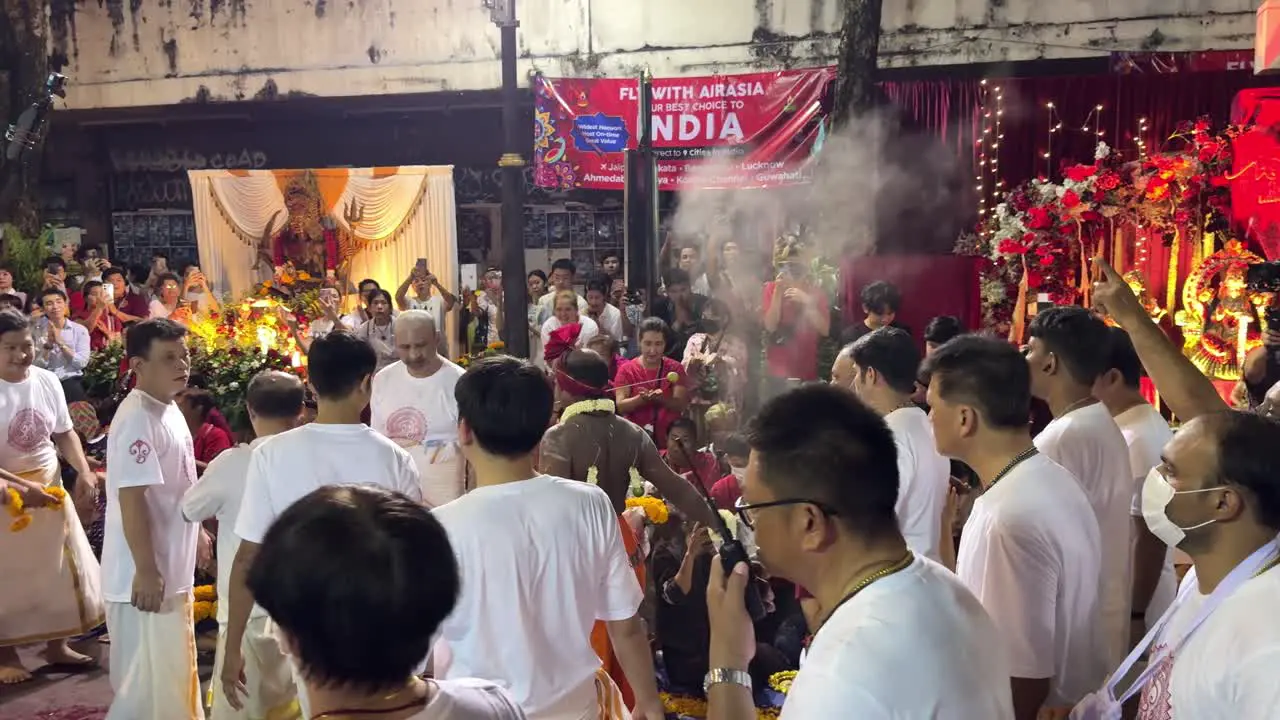 People gathered around the Indian Medium while he blessed the devotees during the rituals of the Navaratri Festival in Bangkok Thailand