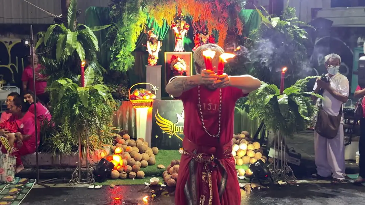 Devotees pray and perform a ritual during the Navaratri Festival celebrating the Goddess Parvati in Bangkok Thailand