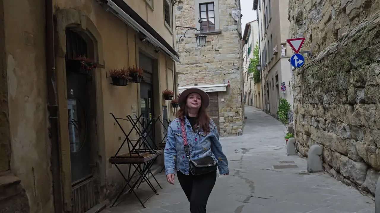 Historic Buildings With A Woman Walking At The Alleys In Arezzo Eastern Tuscany Italy